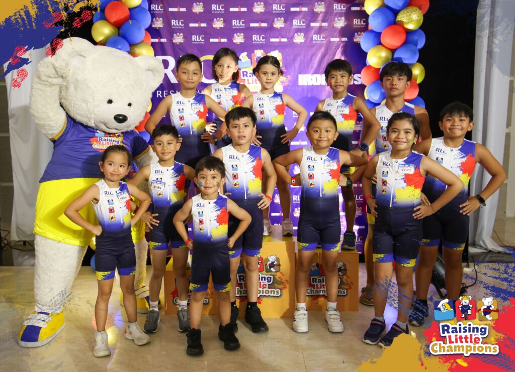 RLC Residences Junior Triathlon Team poses with Bob the Bear